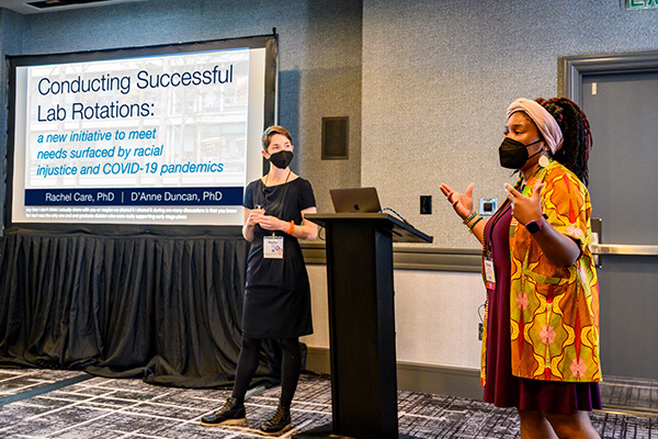 Ray Care, and D'Anne Duncan standing in a conference room next to their talk: Conducting Successful Lab Rotations